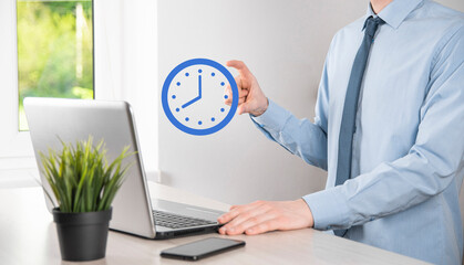 Businessman hand holds the icon of hours clock with arrow. Rapid execution of the work.Business...