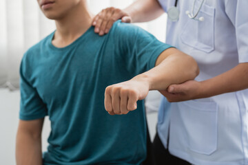 Close-up of a physiotherapist treating a patient at a clinic. - obrazy, fototapety, plakaty