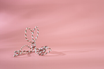 Rope and knot on pink background