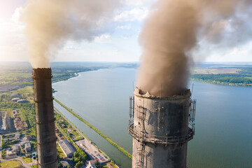 Aerial view of coal power plant high pipes with black smokestack polluting atmosphere. Electricity...