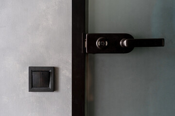 Black electric light switch and door handle