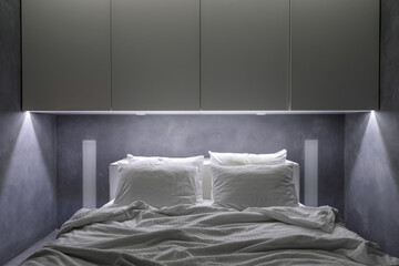 Hotel room with white cupboards and comfort bed