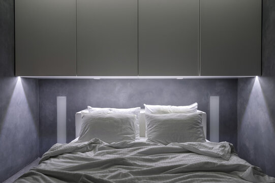 Hotel room with white cupboards and comfort bed
