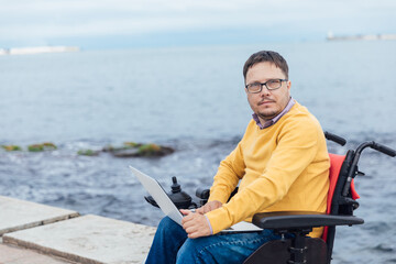 a man with disabilities in a wheelchair working with documents