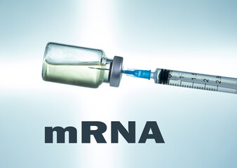 Macro of a hypodermic syringe or needle being filled with mRNA vaccine from bottle against a blue...