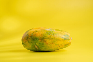 Papaya fruit and skin details on a yellow background