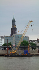 Fototapeta premium st. Michael's church and cranes in the port, Hamburg, Germany