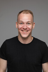 Fototapeta premium Smiling blond man in black t-shirt.