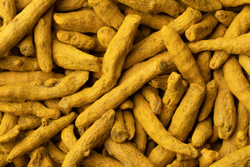 Dried yellow turmeric close up full frame as a background  - obrazy, fototapety, plakaty