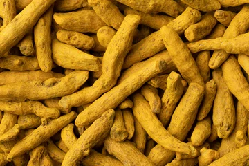 Fotobehang Dried yellow turmeric close up full frame as a background  © Picture Partners