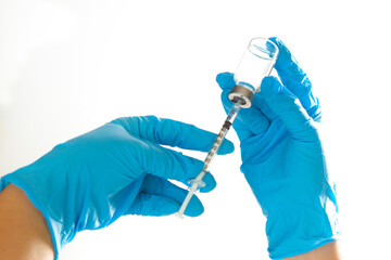 A needle and a vaccination bottle in the doctor's hand.