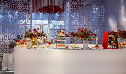 luxury wedding decor with flowers and glass vases and number of setting on round tables
