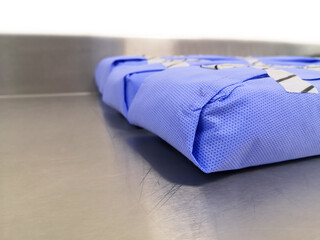 Side View Of Surgical Instruments Set Wrapped With Disposable Blue Drape Sheet