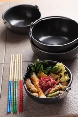 A pot for fish cake soup and fish cake soup.