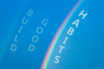 Build good habits symbol. Rainbow in the blue sky. Words Build good habits. Peaceful nature. Beautiful blue background. Business, psychology and build good habits concept, copy space.