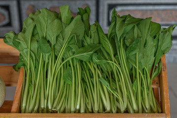green vegetables sold in wooden boxes