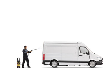 Full length profile shot of a worker in a uniform cleaning a van with a pressure washer machine