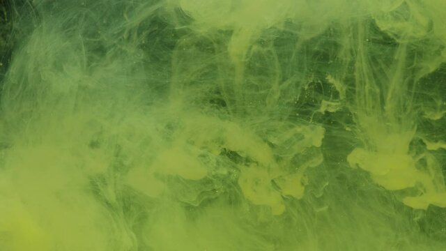 Yellow ink acrylic paint mixing in water, swirling softly underwater. Colored citric acrylic cloud of paint in aquarium. Slow motion abstract smoke explosion animation. Beautiful art background