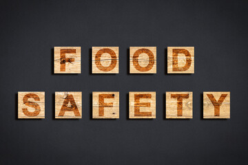 Food Safety and Quality Control in food industry - concept text against a dark background