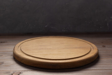 Pizza cutting board for homemade bread cook or baking on table. Empty pizza board at wooden tabletop