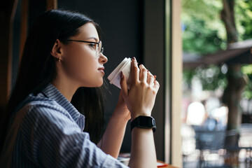 Side view portrait business woman sitting cafe drink hot beverage coffee break have lunch smart...