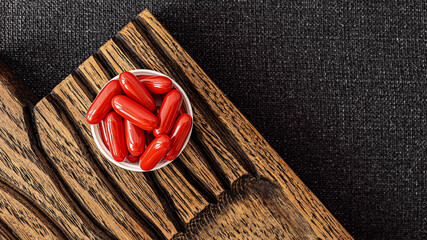 ubiquinol supplement softgels on a wooden desk. dietary supplements top view. mental wellbeing and...