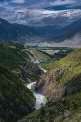 picturesque view of pure rapid river flowing among mountains at summer day 