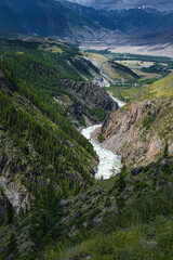 Fototapeta na wymiar picturesque view of pure rapid river flowing among mountains at summer day 