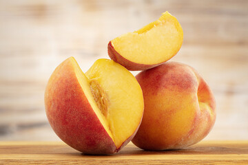 Fototapeta na wymiar Two sliced peaches on a wooden board.