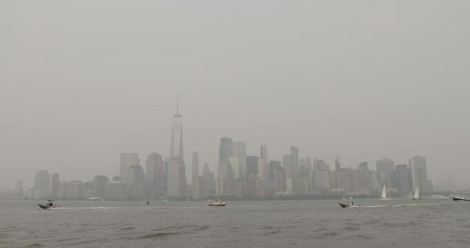 Downtown New York City Skyline With Boat Traffic In Heavy Haze
