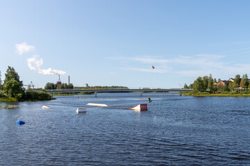 wakeboarder having fun in the wakepark in downtown Oulu on a beautiful summer day