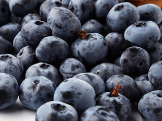 Blueberry fruit top view isolated on a white background, flat lay overhead layout with mint leaf, healthy design concept.