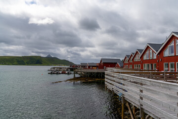 Fototapeta na wymiar colorful red wooden houses on the oceanfront in the Lofoten Islands of Norway