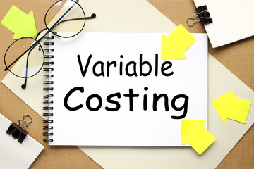 Variable Costing, inscription on a notebook on a craft and gray background