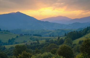 Fototapeta premium The ridgeline of Carpathian mountains in dusk sunlight. Wide-angle mountain range landscape.