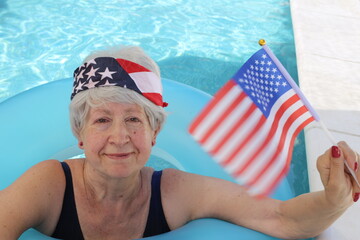 Senior woman celebrating an American holiday in swimming pool