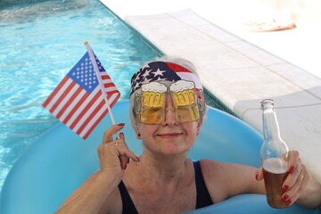 Senior woman celebrating an American holiday in swimming pool  