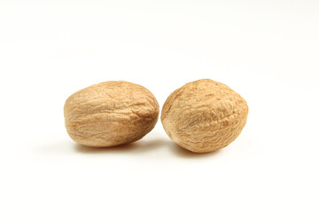 Two brown nutmegs isolated on white background. Muscat