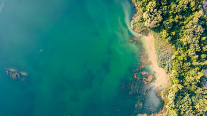 Aerial landscape photography. Aerial top down view of beautiful green waters of lake.