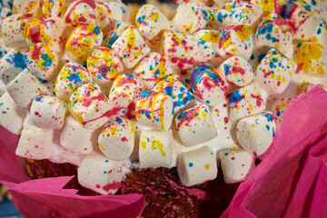 Fototapeta na wymiar Colorful marshmallow on whipped egg whites on Easter cake
