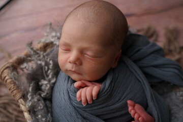 Sleeping newborn boy in the first days of life. Newborn photo session.