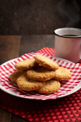 Homemade crunchy cookies and a coffee cup on wooden rustic table