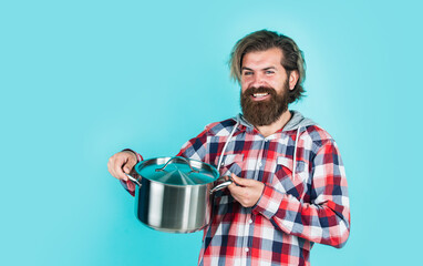 mature handsome man in checkered shirt hold pan for cooking food, cook