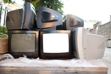 Dump trash can of old CRT TVs with white screens for adding images. Vintage TVs 1980s 1990s 2000s. 