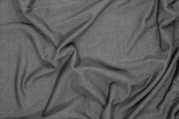Texture of a wrinkled black fabric. Fabric background in dark tone.