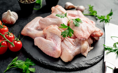 raw chicken wings on stone background