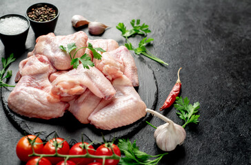  raw chicken wings on stone background   with copy space for your text