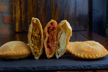 fried venezuelan cake cheese potatoes, meat, fish wood texture