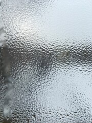 view from the window wet glass covered with wet flowing water, snow melts