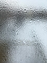 view from the window wet glass covered with wet flowing water, snow melts